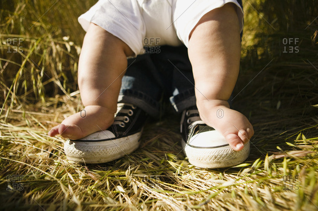 Baby's feet on top of father's feet