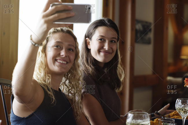 Two women taking selfie together at Thanksgiving dinner