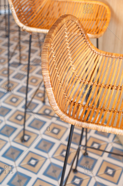Woven rattan chairs on tiled floor