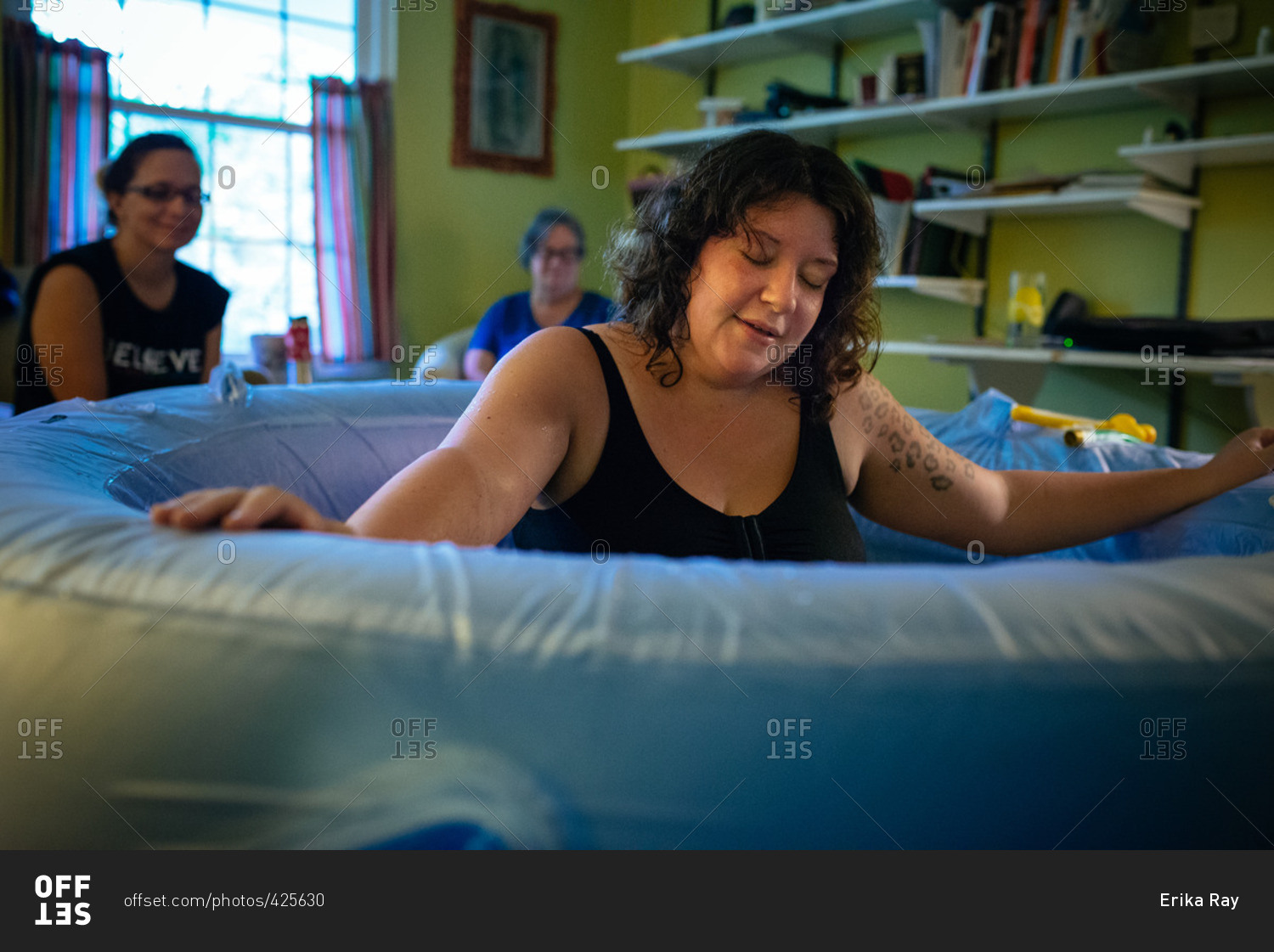 Woman in a birthing tub during a home delivery