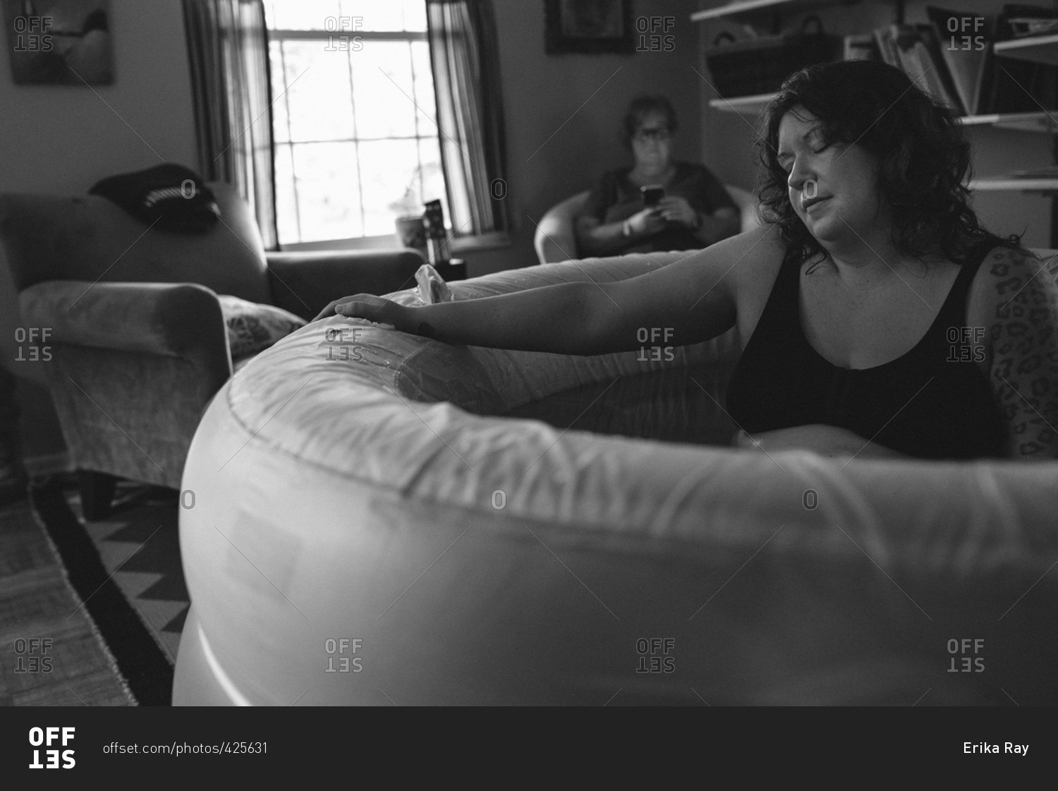 Woman in a birthing tub during a home birth