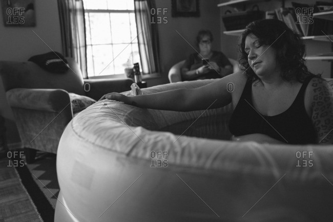 Woman in a birthing tub during a home birth