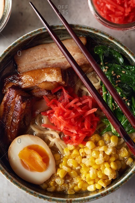 Pork belly ramen served with a soft boiled egg, cooked spinach, sauteed corn and pickled red ginger