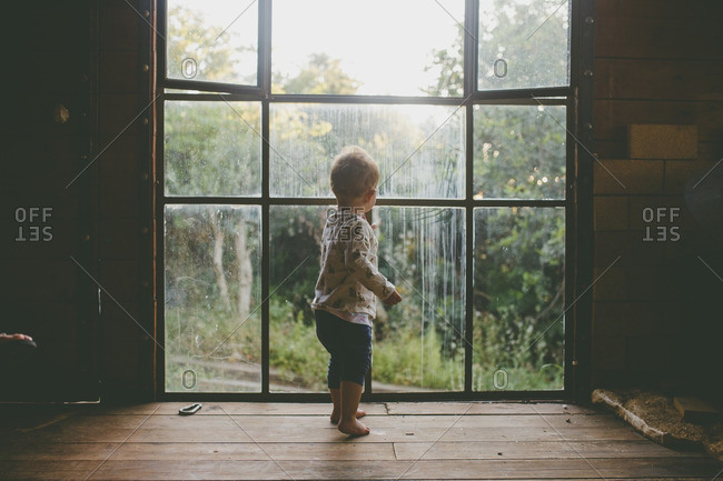 A girl looking outside a window