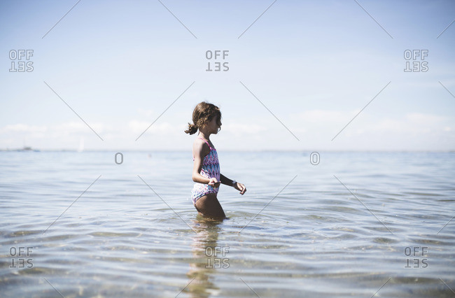 Young girl playing in ocean