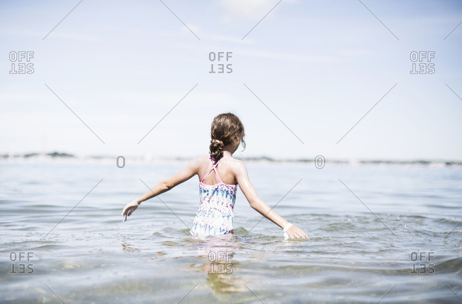 Young girl walking through water