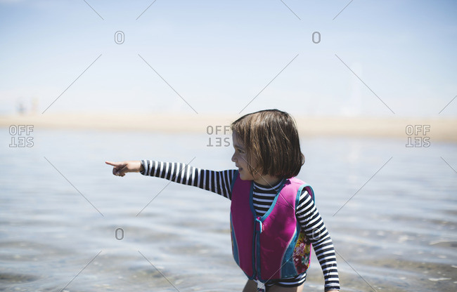 Toddler pointing in ocean
