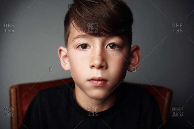 Portrait of a boy in a wooden chair
