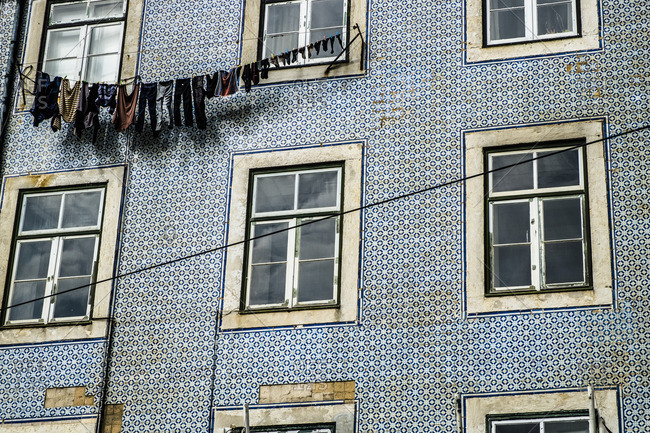 Laundry hanging on side of building in the district of Alfama in Lisbon, Portugal