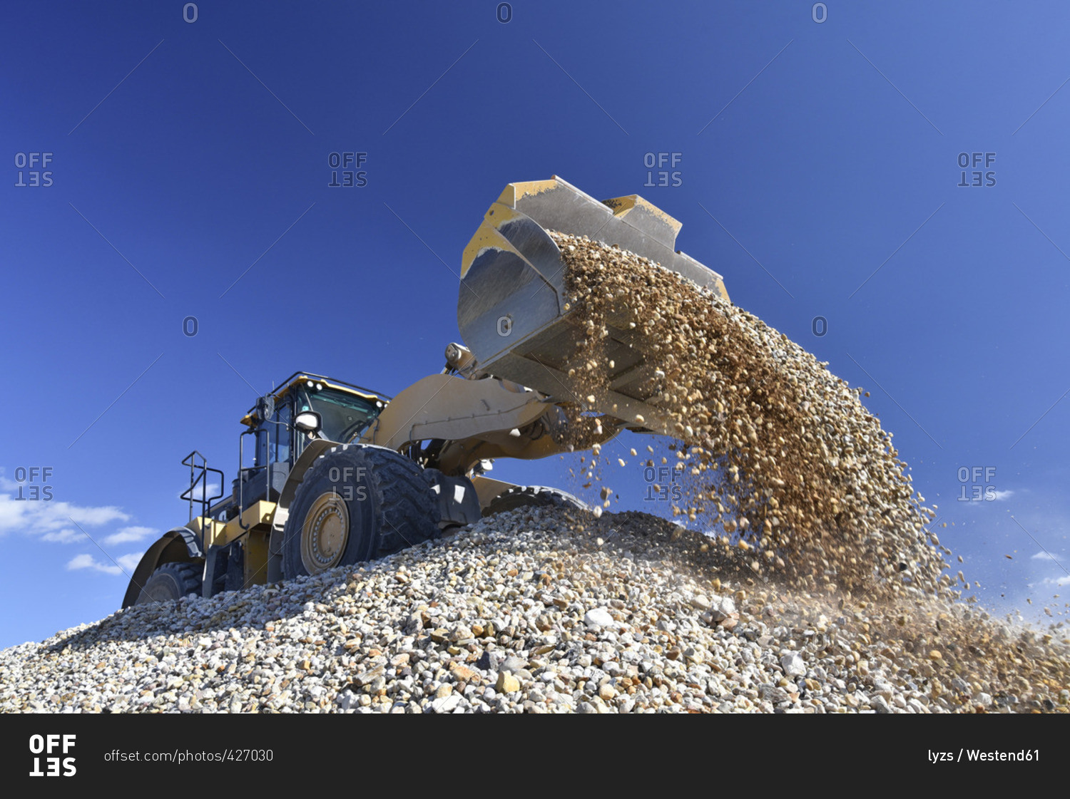 Wheel loader loading stones in gravel pit