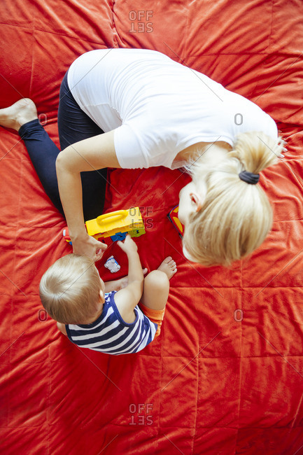 Mother and son playing on bed