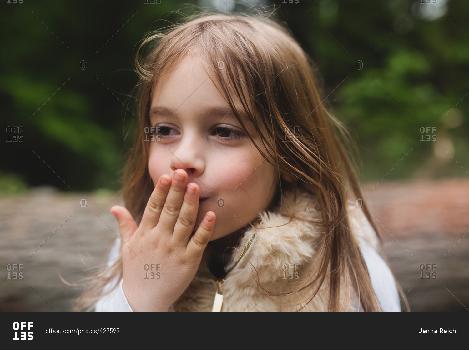 Little girl preparing to blow a kiss stock photo OFFSET