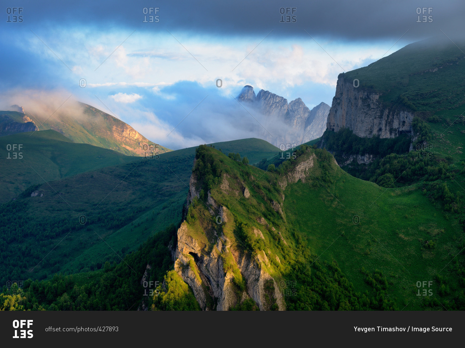 Landscape of storm cloud over Acheshboki (Devil's Gates) mountains in background, Bolshoy Thach (Big Thach) Nature Park, Caucasian Mountains, Republic of Adygea, Russia