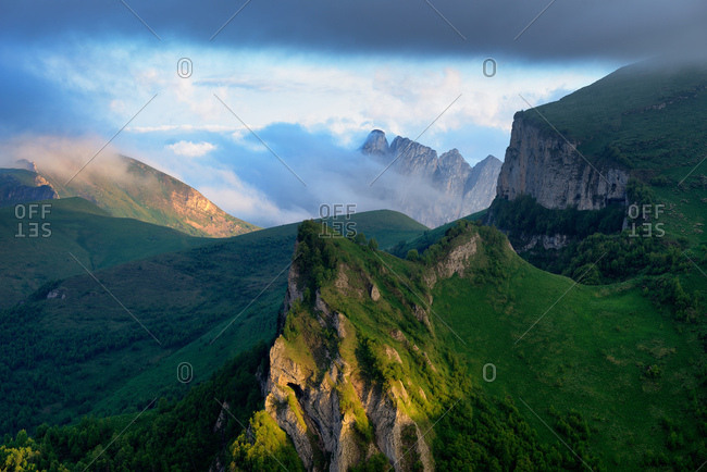 Landscape of storm cloud over Acheshboki (Devil\'s Gates) mountains in background, Bolshoy Thach (Big Thach) Nature Park, Caucasian Mountains, Republic of Adygea, Russia