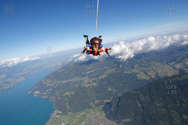 Tandem sky divers free falling as parachute released, Interlaken, Berne, Switzerland