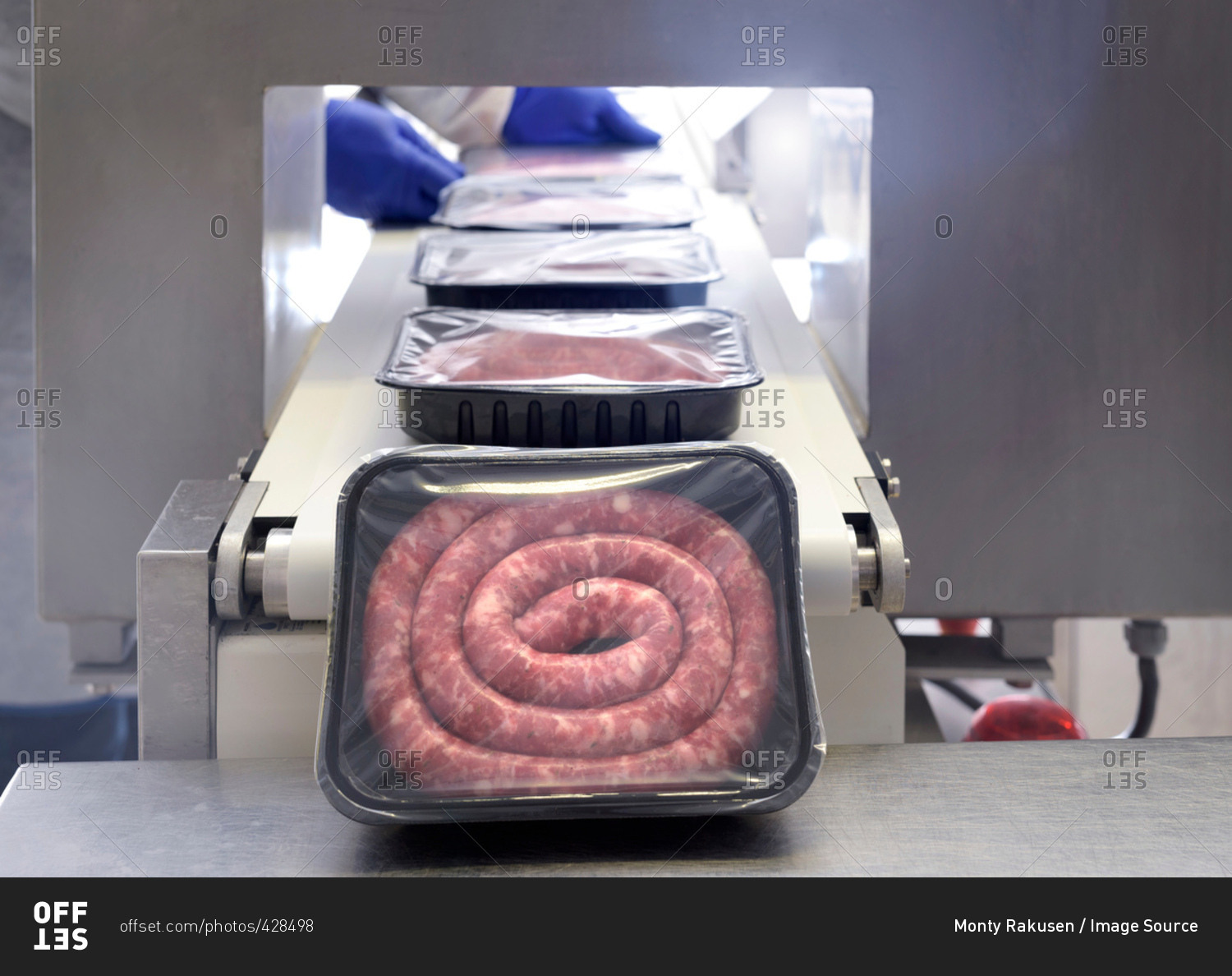 Workers packing Italian sausages in sausage factory