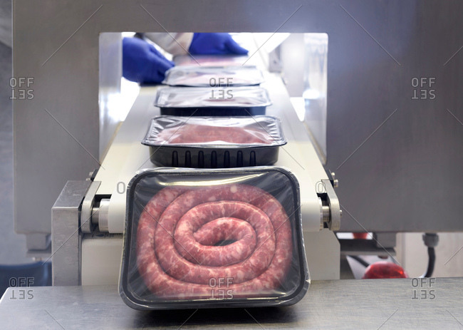 Workers packing Italian sausages in sausage factory