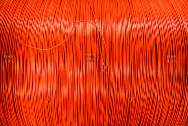 Red cable in cable factory, close up