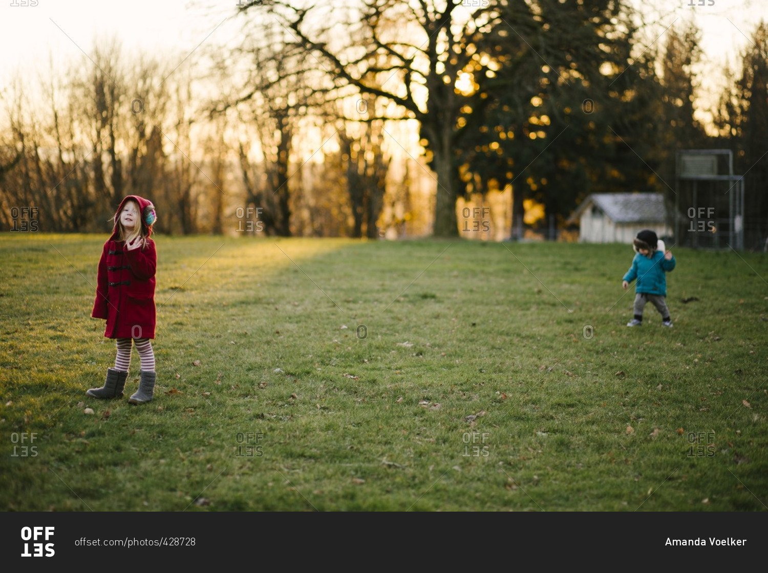 Siblings in a cold rural yard