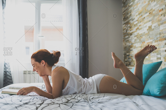 Sexy woman in underwear on bed stock photo - OFFSET