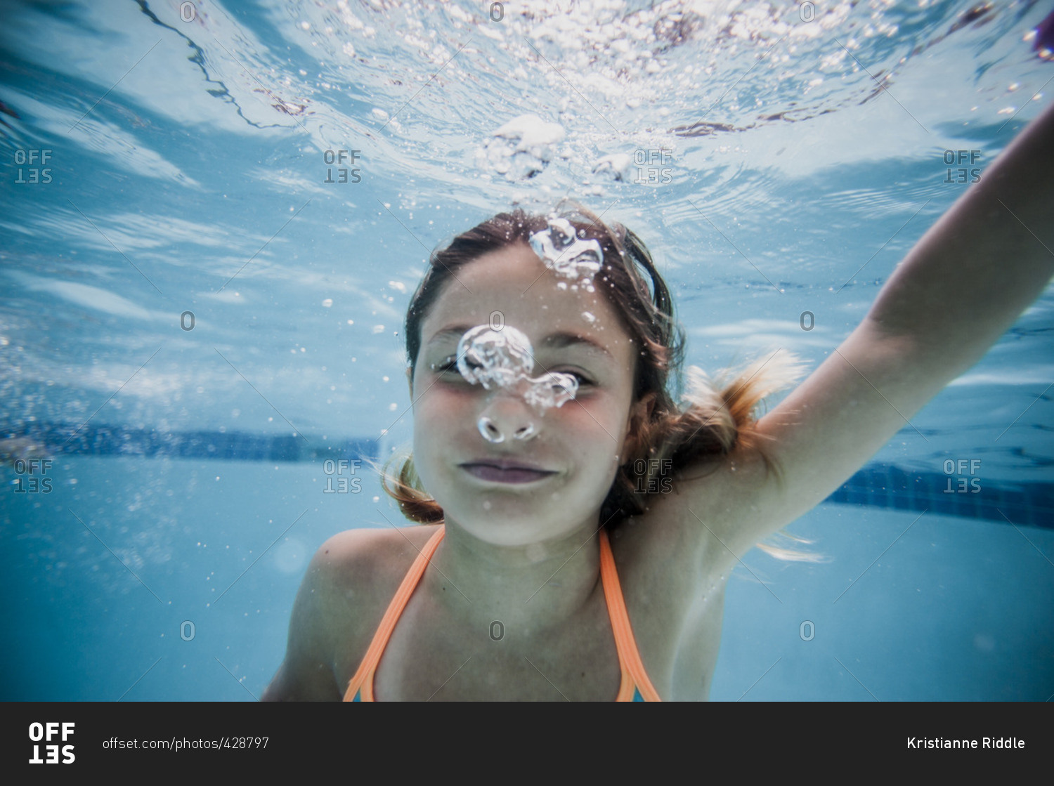 Underwater portrait of girl in a swimming pool stock photo - OFFSET