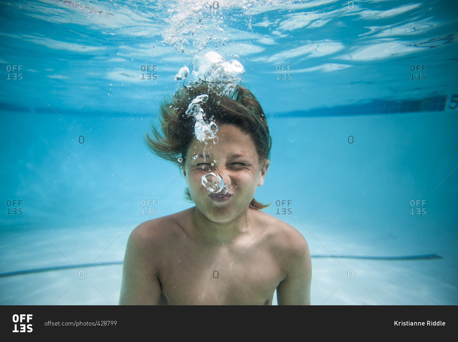 Underwater portrait of boy in a swimming pool stock photo - OFFSET