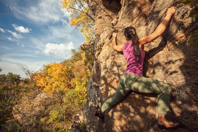 Woman rock climbing in autumn