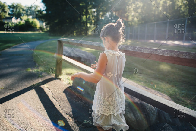 Girl Walking In The Morning Sunlight Stock Photo - OFFSET