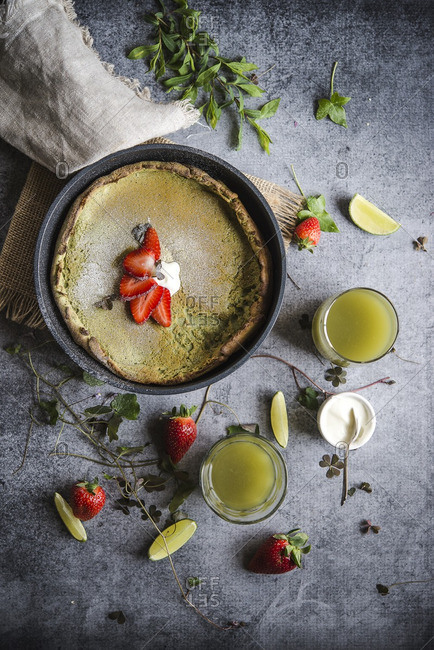 Matcha Dutch baby pancake with  sliced strawberries