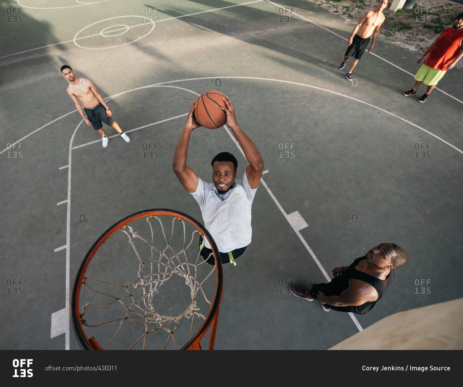 High angle view of friends on basketball court scoring basketball hoops