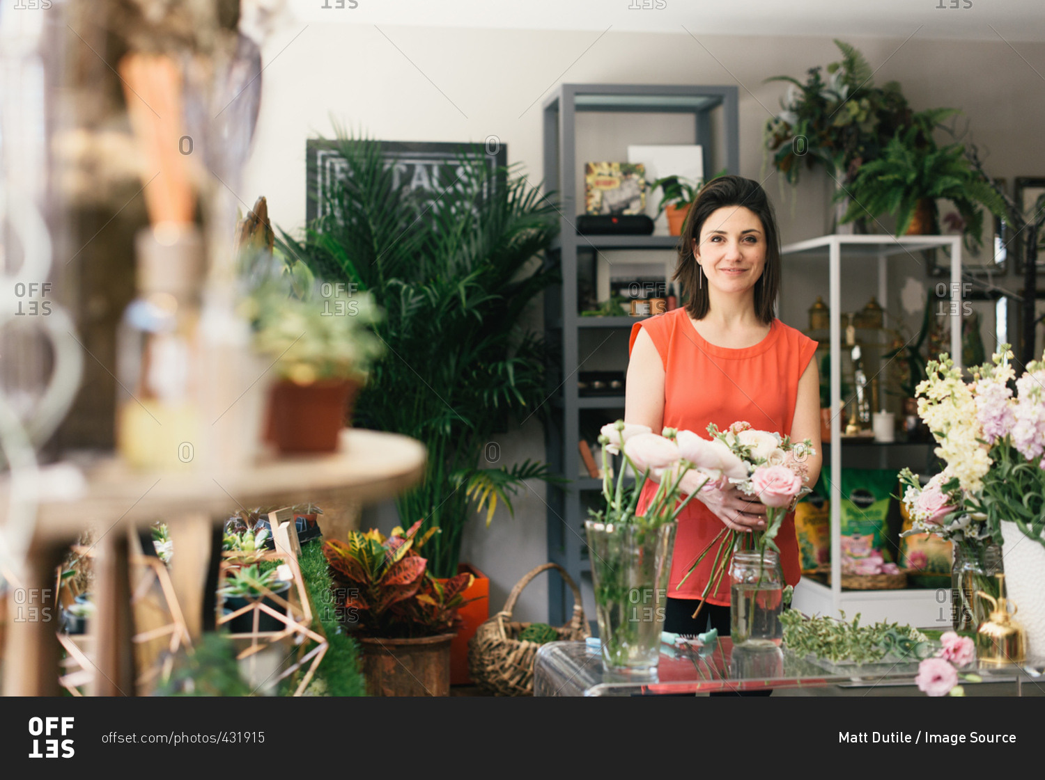Portrait of florist arranging bouquet in flower shop