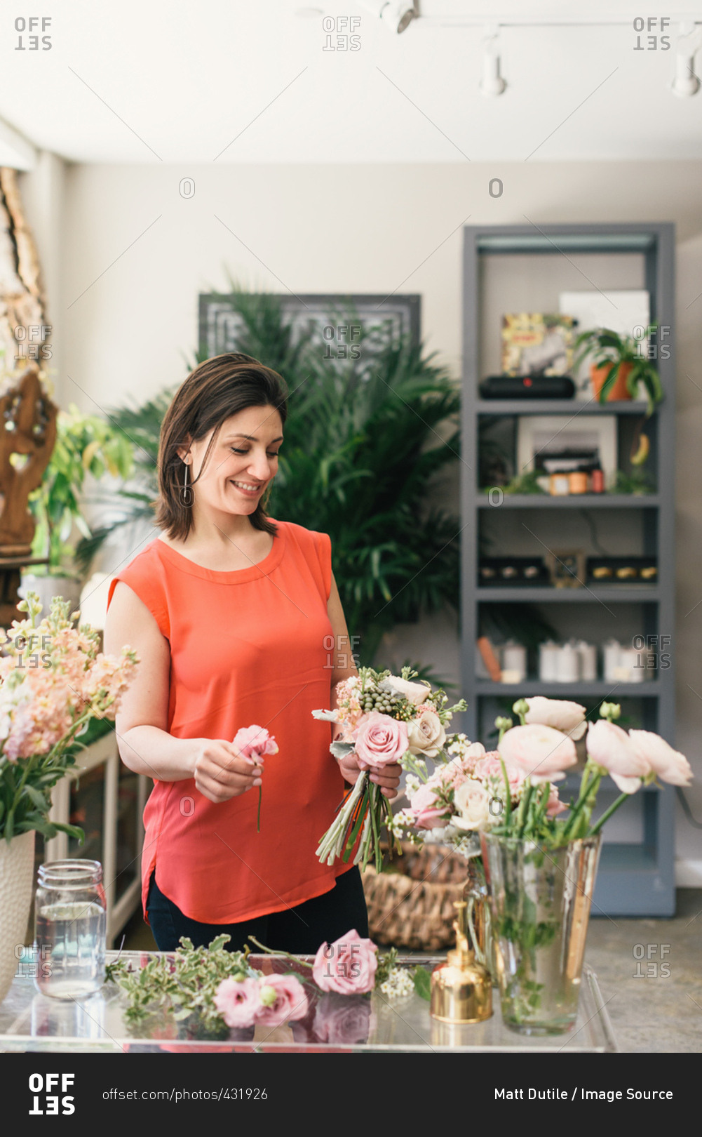 Florist arranging bouquet in flower shop