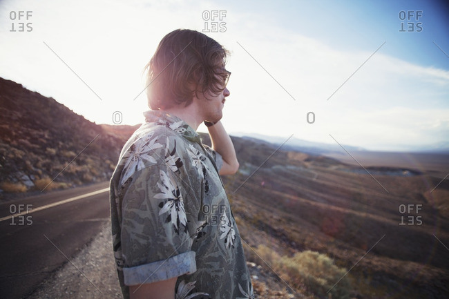 Young man looking off into the distance at scenic viewpoint in Death Valley, California