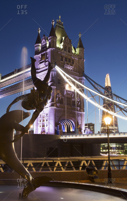 Statue of a girl with dolphin near the Tower Bridge, London