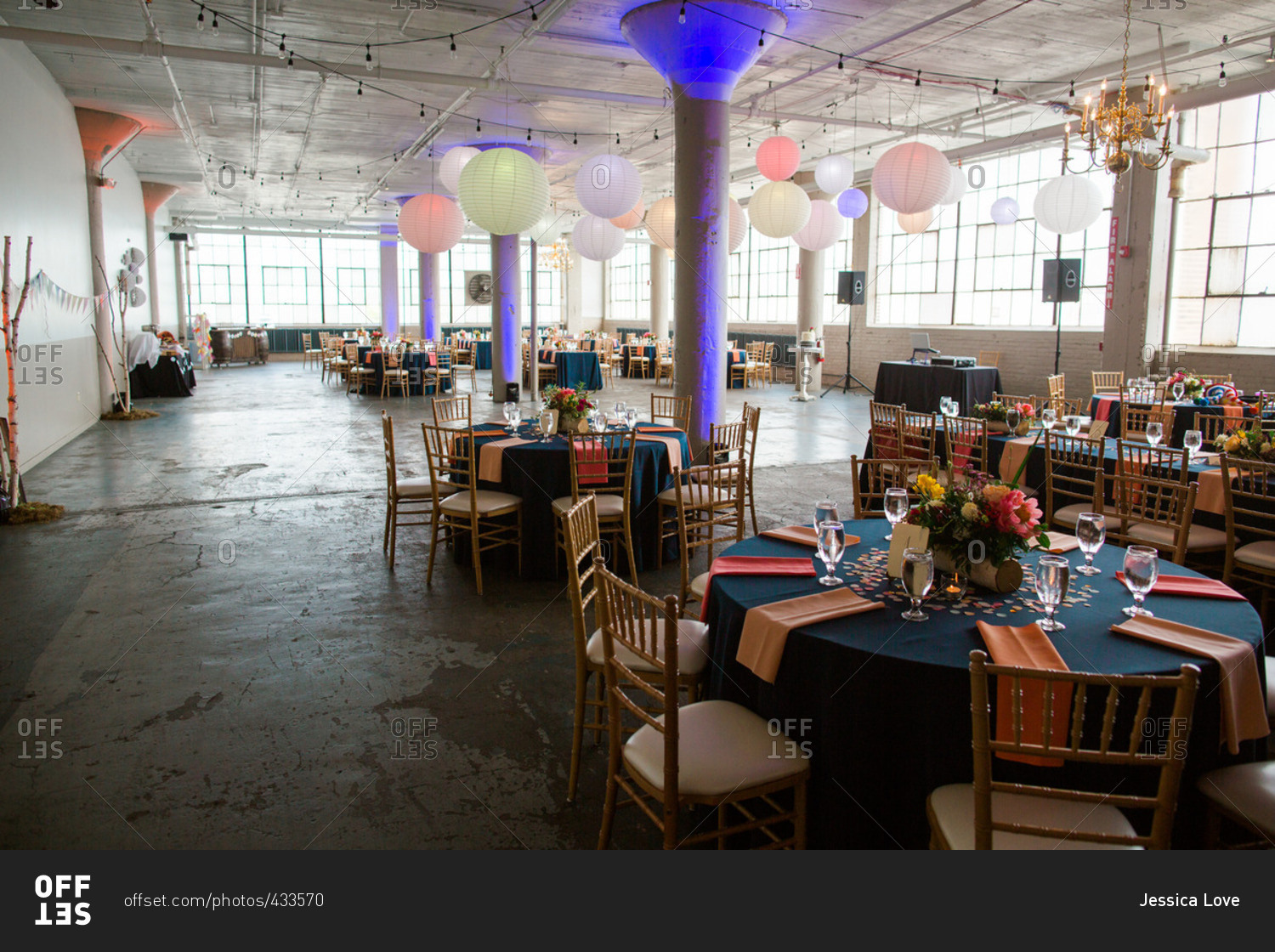 Colorful decorations at a warehouse wedding reception stock photo - OFFSET