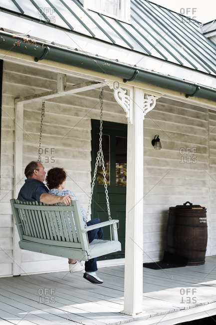 May 2 2016 Couple Sitting On A Swing On The Front Porch Of A