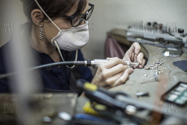 Goldsmith working on jewelery in workshop