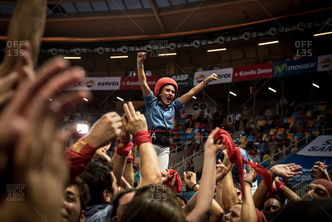 Members of the 'Marrecs de Salt' human tower team after forming a 'castell' (human tower) during the XXVI human towers, or 'castells', competetion in Tarragona on October 1, 2016.