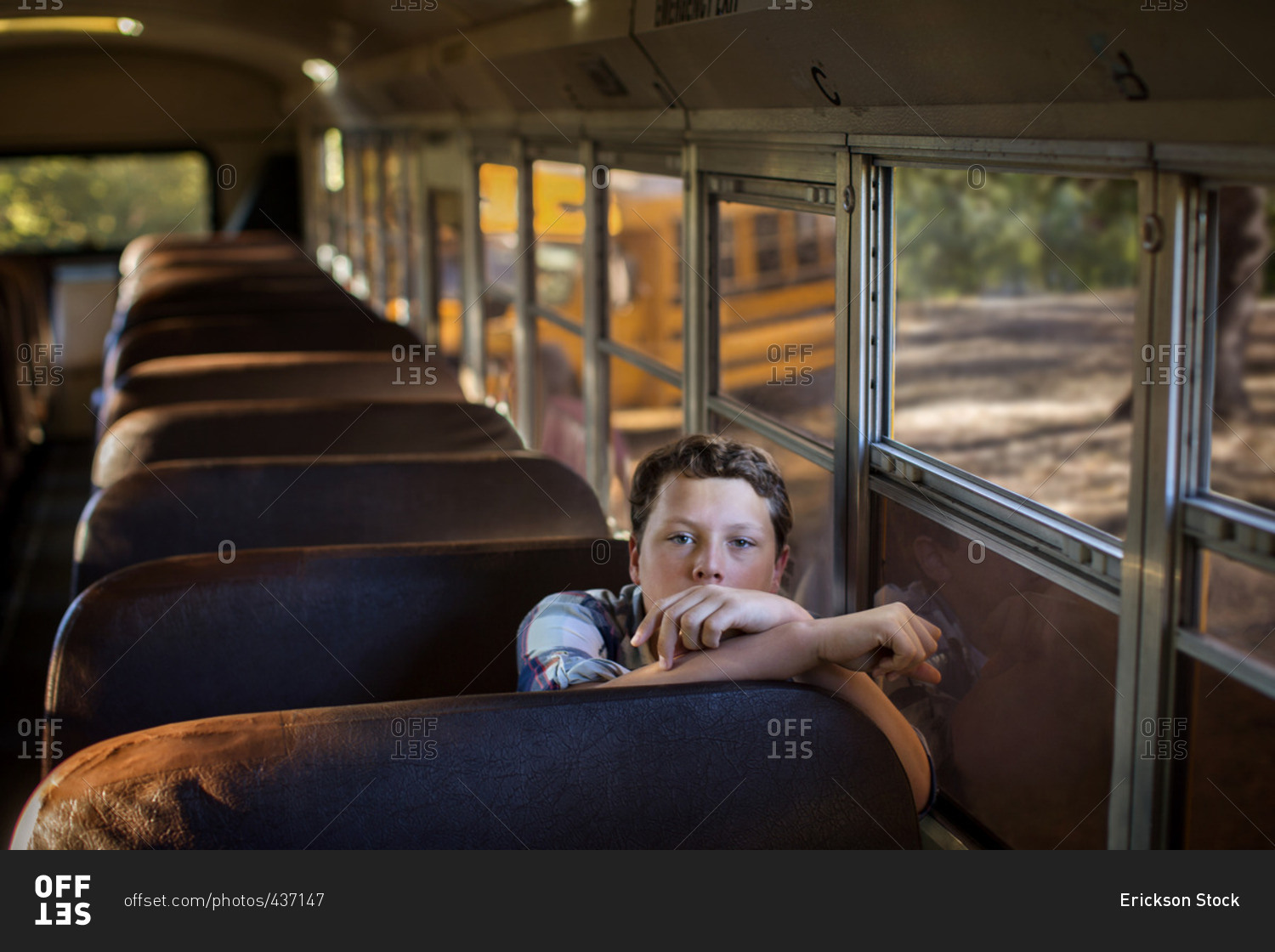 Young boy alone on a school bus.