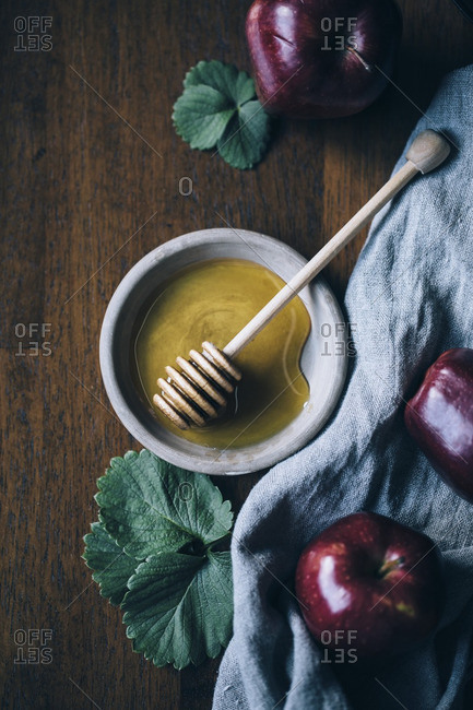 Apples and honey with a honey dipper