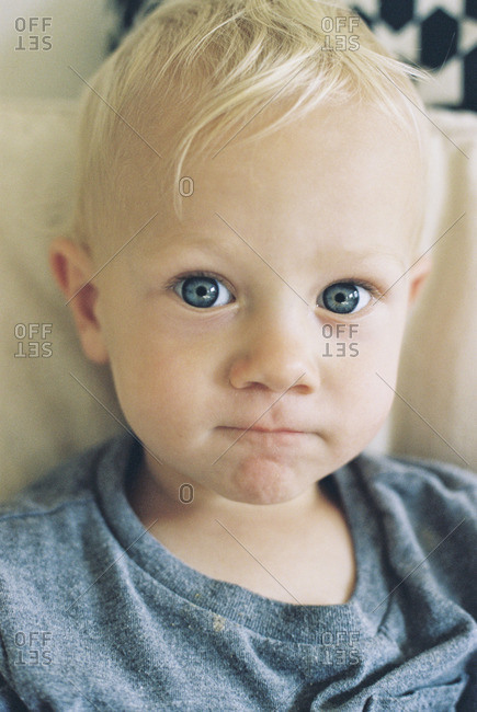 Portrait Of A Toddler Boy With Blonde Hair And Blue Eyes Stock