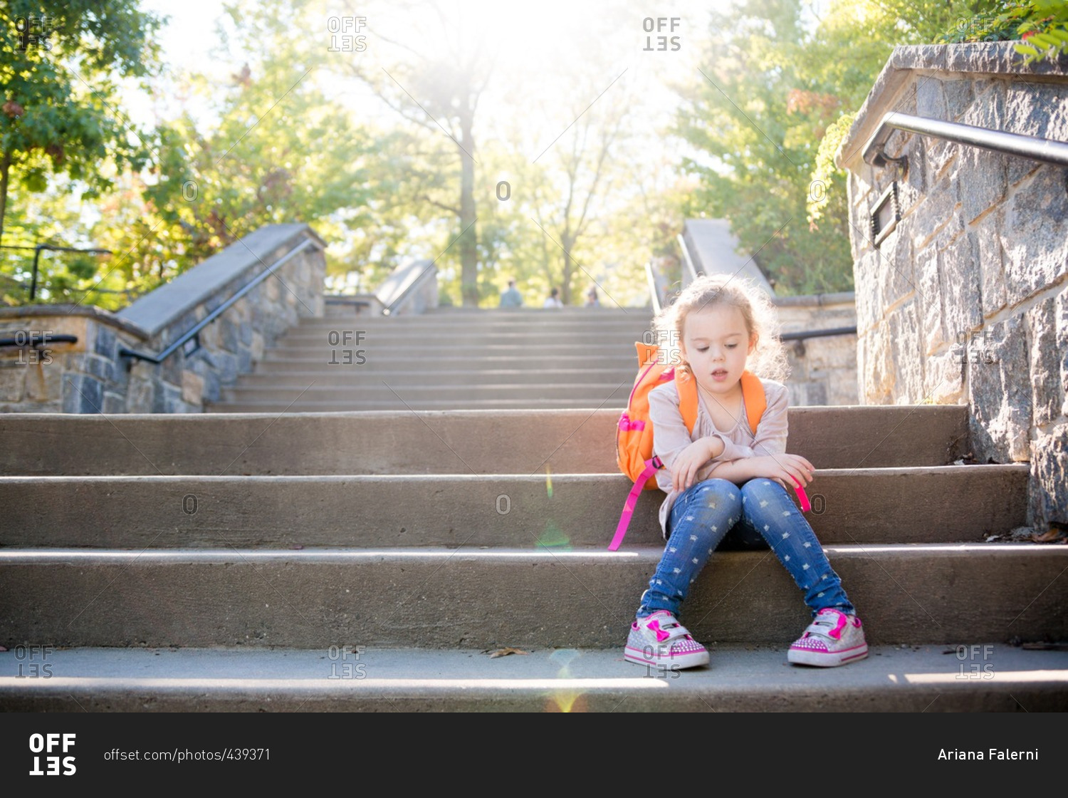 Girl with backpack on outdoor steps
