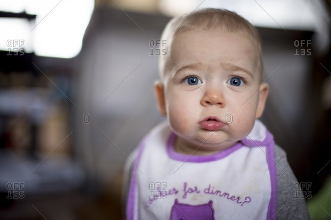 A  blue eyed baby wearing a bib