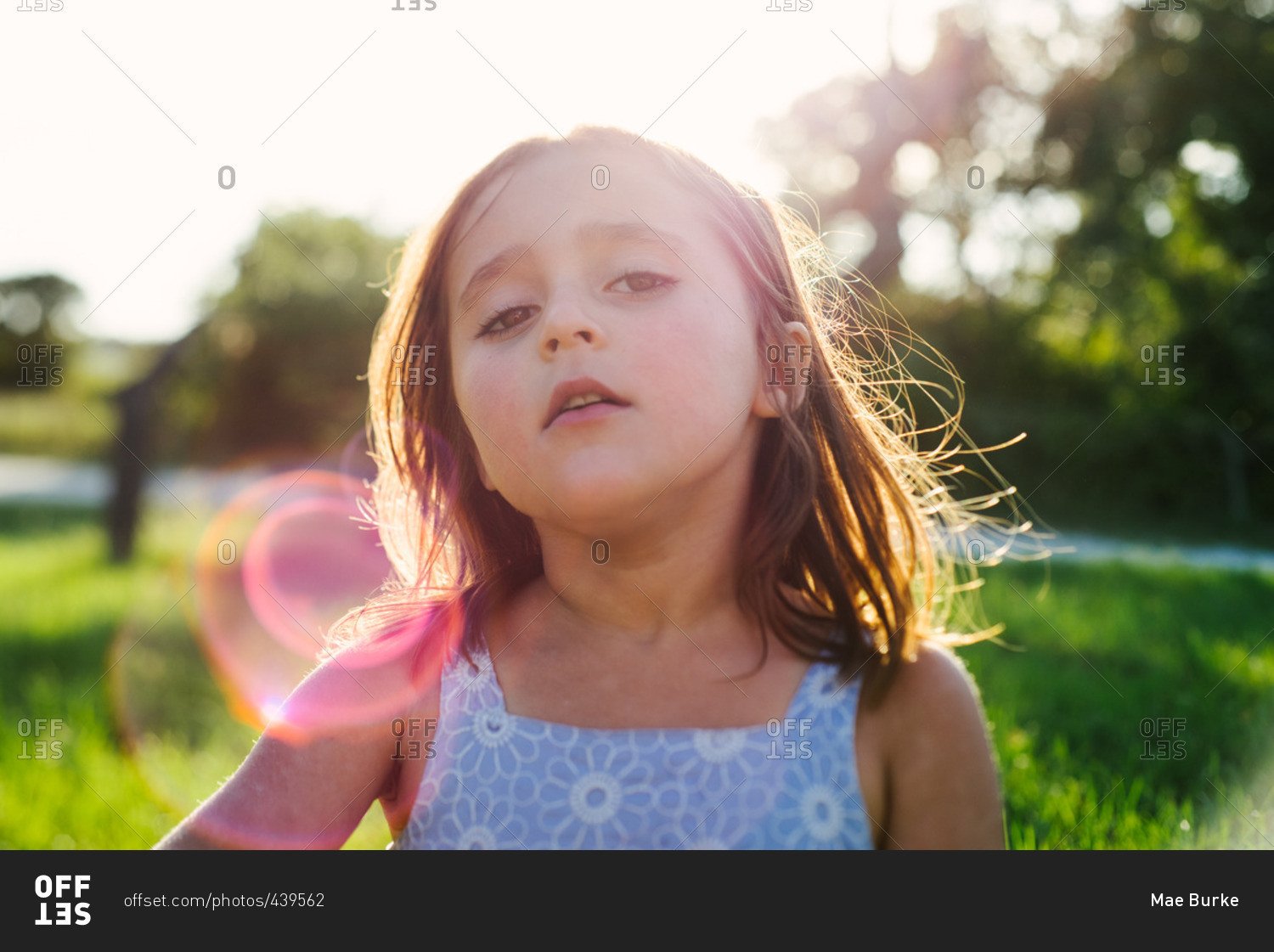 Girl in sun flare in field