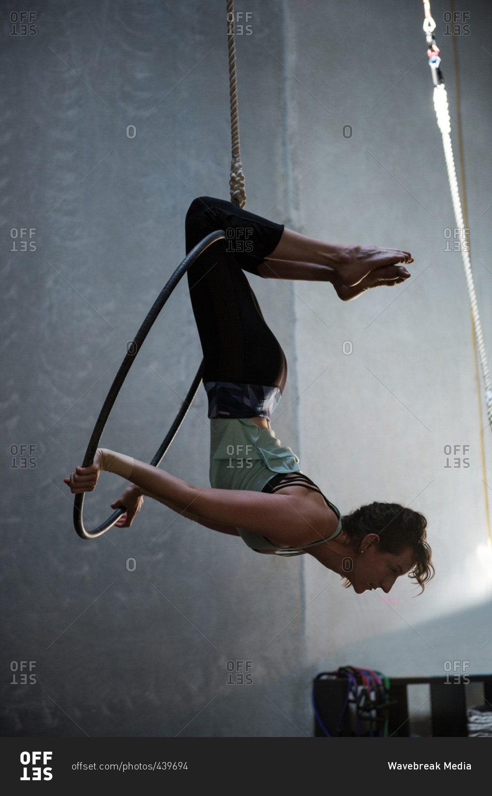 Gymnast performing gymnastics on hoop stock photo - OFFSET