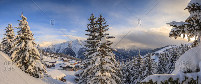 Panorama of snowy woods and mountain huts framed by sunset, Bettmeralp, district of Raron, canton of Valais, Switzerland, Europe