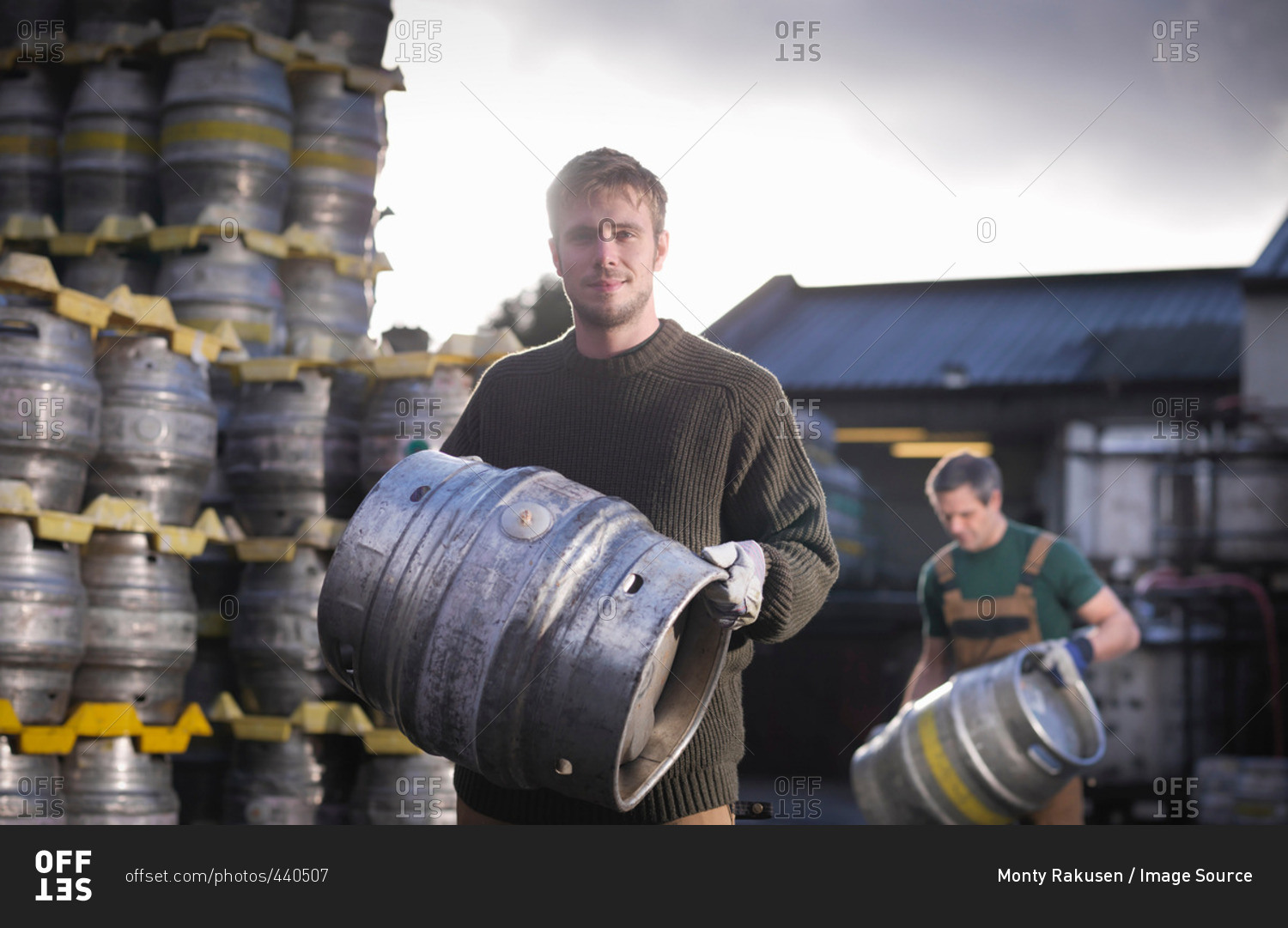 Workers with barrels outside brewery