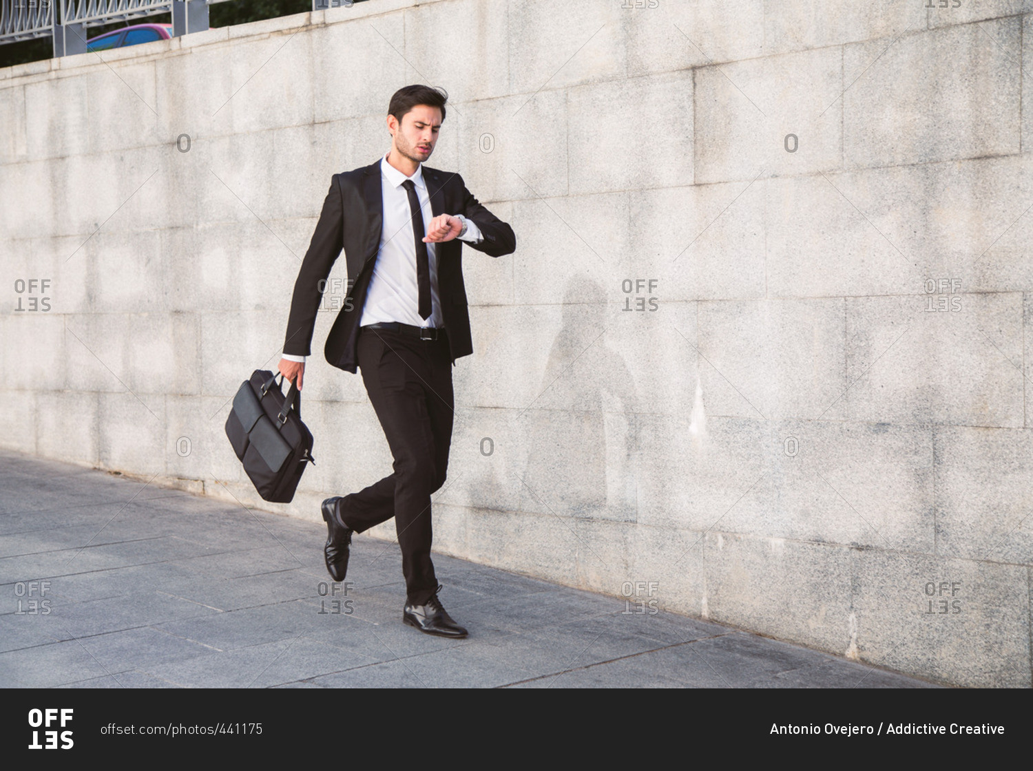 Businessman trying to stop time Stock Photo by ©kantver 69891211