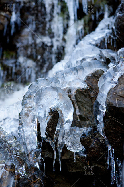 Icicles dripping over rocks - Offset