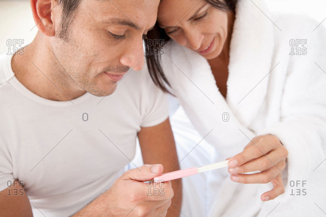 Couple reading pregnancy test together